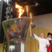 Will Hardy, the last torchbearer of Day 28, lights the cauldron to keep the flame alive overnight. Picture: LOCOG