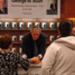 Bush shakes hands with a fan at the Houston Barnes and Noble