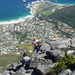 This guys is rapelling down the side of the mountain.