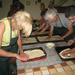 Prepping pizza in class at a working farm