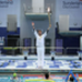 Steve Cram holds the Torch aloft at the Sunderland Aquatic Centre. Picture: LOCOG