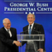 George W. Bush shakes hands with Dick Cheney at SMU