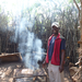 Another community member toasting bread over the braai (barbeque)