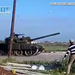 Syrian protester hurls rocks at tank