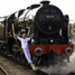 Josephine Loughran carries the Olympic Flame on the Scots Guardsman steam locomotive as they make the journey from York to Thirsk.