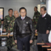 South Korean President Lee Myung-bak, center, arrives with Defense Minister Kim Tae-young, second right, at the Joint Chiefs of Staff as the military was put on top alert after North Korea's artillery attack.